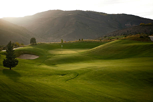A person swinging a golf club.